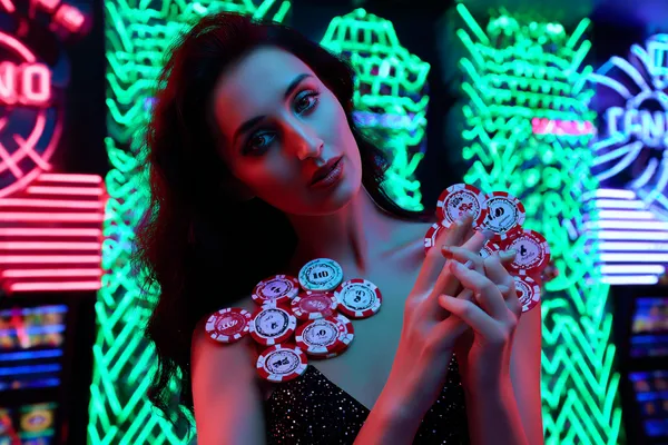 Uma mulher elegante ao lado de máquinas caça-níqueis vibrantes exibindo setes brilhantes, mostrando a variedade de slots no BBB22.